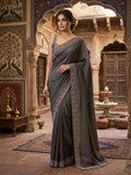 Woman in a grey embellished saree.